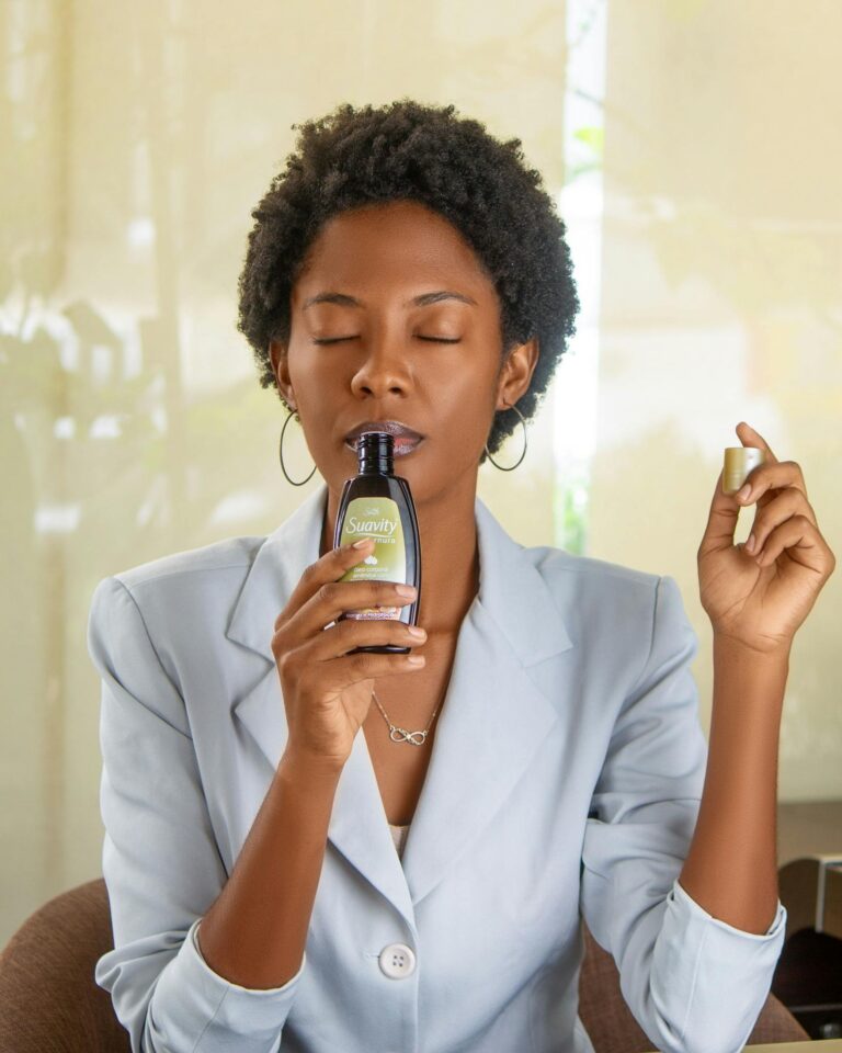 Sophisticated woman indoors relaxing and enjoying the fragrance of a scented product.